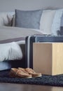 Brown leather shoe and luggage on black rug next to bed in bedroom Royalty Free Stock Photo