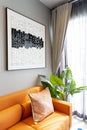 Brown leather sofa with blue and orange pillow in entertainment of luxury home.