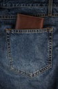 A brown leather wallet the back pocket of blue shabby jeans hipster modern life style layout for inserting text