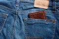 Brown leather wallet in the back pocket of a blue jean Royalty Free Stock Photo
