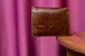 Brown leather wallet on edge of table