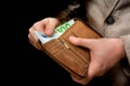 Brown leather wallet with euro money in male hands Royalty Free Stock Photo