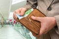 Wallet with euro money in male hands in shopping centre Royalty Free Stock Photo