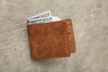 Brown leather wallet with money on grey background Royalty Free Stock Photo