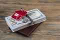 Brown leather wallet with one hundred dollar bills on wooden table. Top view Royalty Free Stock Photo