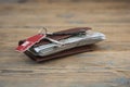 Brown leather wallet with one hundred dollar bills on wooden table. Top view Royalty Free Stock Photo