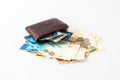 Brown leather wallet and several credit cards, club cards, stack of banknotes and several coins of new Israeli shekels isolated on Royalty Free Stock Photo