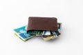 Brown leather wallet and several credit cards, club cards and stack of banknotes new Israeli shekels isolated on white background Royalty Free Stock Photo