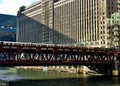 Brown line el train crosses elevated track over the Chicago River alongside the Merchandise Mart. Royalty Free Stock Photo