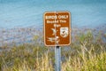 A brown with logo signboard caution sign in Laguna Atascosa NWR, Texas