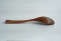 Brown long handle wooden spoon on white background Royalty Free Stock Photo