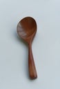 Brown long handle wooden spoon on white background Royalty Free Stock Photo