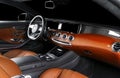 Brown luxury modern car Interior with steering wheel and dashboard. Detail of modern car interior. Automatic gear stick. Part of