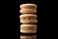 Brown macaroon cookies on a black background