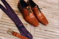 Brown man`s shoes with laces on a wooden background and a brown Royalty Free Stock Photo