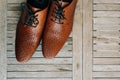 Brown man shoes with laces on wooden background Royalty Free Stock Photo