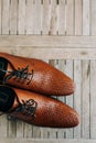 Brown man shoes with laces on wooden background Royalty Free Stock Photo