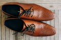 Brown man shoes with laces on wooden background Royalty Free Stock Photo