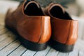 Brown man shoes with laces on wooden background Royalty Free Stock Photo