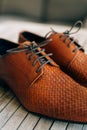 Brown man shoes with laces on wooden background Royalty Free Stock Photo