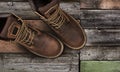 Brown men`s boots, on a wooden background Royalty Free Stock Photo