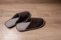 Brown men`s slippers stand on the oak floor Royalty Free Stock Photo