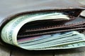 Brown mens wallet and dollars - macro photo