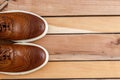 Brown mens shoes on wooden backgorund. top view Royalty Free Stock Photo