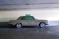 Brown Mercedes Benz parked in parking with white concrete wall background. Vintage or retro car on street. Classic vehicle Royalty Free Stock Photo