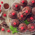 Brown muffins with raspberries and chocolate fresh baked square