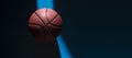Brown new basketball ball with natural lighting on blue background. Sport team concept. Horizontal sport theme poster, greeting ca Royalty Free Stock Photo