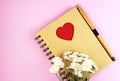 A brown notebook with flowers on a pink background Royalty Free Stock Photo