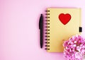 Brown notebook with flowers on a pink background Royalty Free Stock Photo