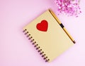 Brown notebook with flowers on a pink background Royalty Free Stock Photo