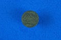 brown old egypt coin lies on a blue background