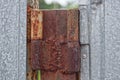 Brown old rusty iron hinge on a gray metal door Royalty Free Stock Photo