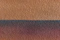 Brown orange plaster wall two colors abstract pattern design stucco background texture empty blank Royalty Free Stock Photo