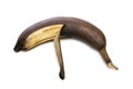 Brown overripe banana on a white background