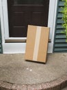 A brown package is left vulnerable at front door Royalty Free Stock Photo