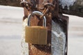 A brown padlock hanging on a rusty iron chain Royalty Free Stock Photo