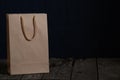 Brown paper bag on dark background close up