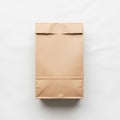 Brown paper bag with a folded top placed on a plain white surface Royalty Free Stock Photo