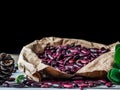 Brown paper bag full of a pile of raw red kidney beans