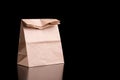 Brown paper bag for lunch or food on a black background with copy space Royalty Free Stock Photo