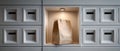 Brown paper bag placed in illuminated white cubbyhole surrounded by multiple closed white mailboxes in modern setting Royalty Free Stock Photo