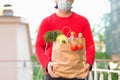 Brown paper bag with vegetables, in the hands of a man