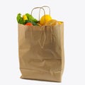 Brown paper bag with vegetables. Recycled pack with fresh organic food isolated on white background