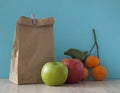 School lunch. Brown paper breakfast bag and mixed fruit Royalty Free Stock Photo