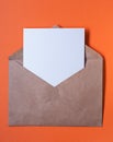 Brown paper envelop with blank letter inside on orange