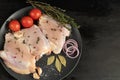 On brown paper, fresh skinless chicken thighs, next to mushrooms, with tomatoes, red onions and thyme. Recipe of dish. Ingredients Royalty Free Stock Photo